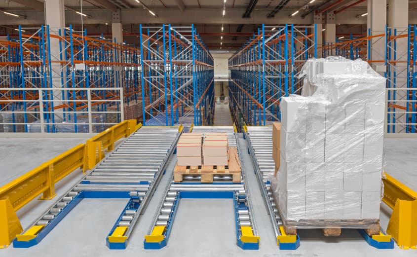 Pallet handling system with roller conveyors and transfer units